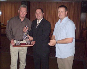 Nick Smith receives his decanter set from Nat Coles and Pete Mills