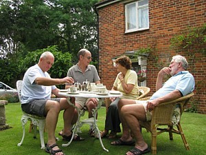Holloway, Hoole, Jill and Barlow enjoy tea on the lawn 