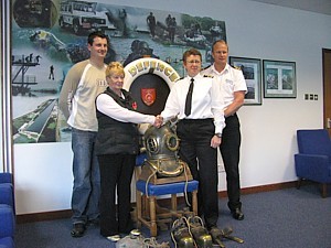 Ginger's daughter Jackie Parrish presents his diving artefacts to Jack McWilliams (on behalf of DDS) flanked by Ginger's grandson Chris Ward and Soapy Watson