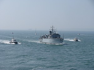 HMS Brocklesby appears out of the haze