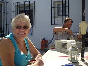 Jon fixes his toaster while Linda concentrates on her 'sun' crossword