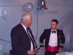 Peter Harrison, Vice Chairman of the TCA, presents a TCA badge to HMS Cattistock's CO