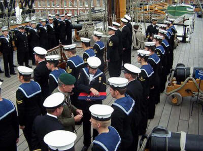 HMS Cattistock's ship's company being presented with Iraq Operational Service Medals on board HMS Victory by Maj Gen Jim Dutton RM