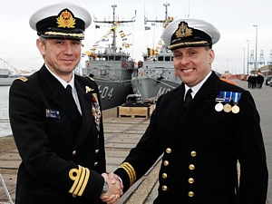 Cdr Serge Ots BN handing over to Cdr Chris Davies RN